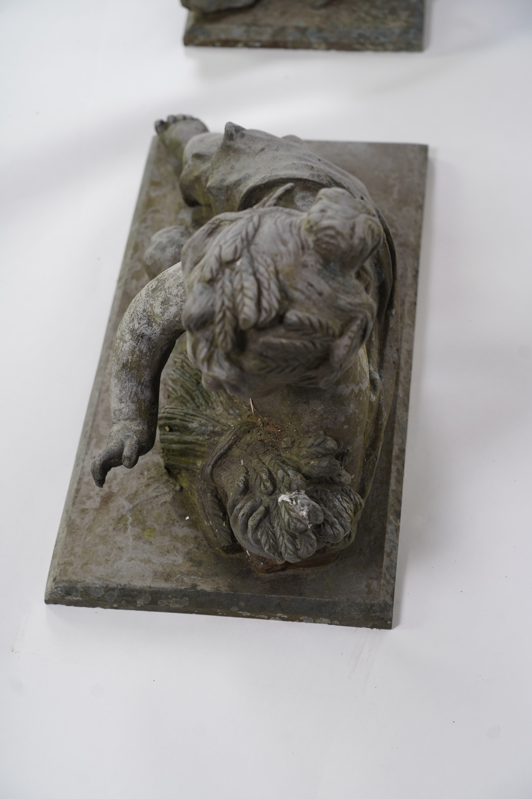 A pair of simulated lead garden sculptures, Emblematic of Summer and Autumn